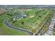 Aerial view of community with clubhouse, pool, and golf course at 2366 Prairie Dunes, Clermont, FL 34711