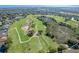 Aerial view of a golf course community with houses and lush green landscape at 2366 Prairie Dunes, Clermont, FL 34711