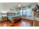 Spacious bedroom with wood floors, large window, and ceiling fan at 2366 Prairie Dunes, Clermont, FL 34711