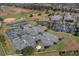 Aerial view of community tennis courts and surrounding landscape at 2366 Prairie Dunes, Clermont, FL 34711