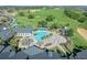 Resort-style pool with lounge chairs, landscaping and clubhouse in background at 2366 Prairie Dunes, Clermont, FL 34711