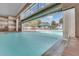 Indoor pool with waterfall feature and access to outdoor pool at 2366 Prairie Dunes, Clermont, FL 34711