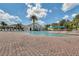 Community pool with brick patio and lounge chairs at 2366 Prairie Dunes, Clermont, FL 34711