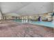 Indoor pool with brick floor and large windows at 2366 Prairie Dunes, Clermont, FL 34711