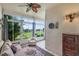 Relaxing enclosed patio features comfy seating, ceiling fan, and picturesque golf course view at 2366 Prairie Dunes, Clermont, FL 34711