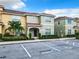 Townhouse exterior, two-story, light green and yellow, with parking at 8967 California Palm Rd, Kissimmee, FL 34747
