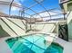 Private screened-in pool with lounge chairs at 8967 California Palm Rd, Kissimmee, FL 34747