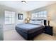 King-size bed, nightstands, and large windows in this bright bedroom at 8967 California Palm Rd, Kissimmee, FL 34747
