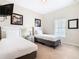 Bedroom with two twin beds, nightstand, and window at 8967 California Palm Rd, Kissimmee, FL 34747