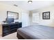 Spacious bedroom with a king-size bed, dresser, and TV at 8967 California Palm Rd, Kissimmee, FL 34747
