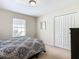 Bedroom with queen bed, dresser, and window at 8967 California Palm Rd, Kissimmee, FL 34747