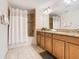 Double vanity bathroom with granite countertop, shower, and bathtub at 8967 California Palm Rd, Kissimmee, FL 34747