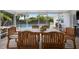 Screened patio with wooden dining set and pool view at 115 Marcy Blvd, Longwood, FL 32750