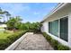 Charming brick patio with lush landscaping and a view of the home at 115 Marcy Blvd, Longwood, FL 32750