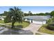 Single story home with white exterior and a two-car garage at 115 Marcy Blvd, Longwood, FL 32750