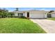 One-story home with white siding and a large front yard at 115 Marcy Blvd, Longwood, FL 32750