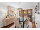 Modern dining room with hardwood floors, a black table, and access to the backyard at 115 Marcy Blvd, Longwood, FL 32750
