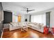 Living room with hardwood floors, large sectional sofa, and access to other rooms at 115 Marcy Blvd, Longwood, FL 32750