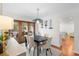 Modern dining room with hardwood floors, a black table, and access to the backyard at 115 Marcy Blvd, Longwood, FL 32750