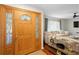 Bright entryway with hardwood floors, a wood door, and access to the living room at 115 Marcy Blvd, Longwood, FL 32750