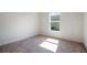 Well-lit bedroom featuring a window and carpet flooring at 225 Goldenrod Ln, Poinciana, FL 34759