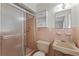 Pink tiled bathroom with shower, sink, and toilet at 2009 Lakeshore Blvd, Saint Cloud, FL 34769