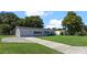 Gray house with a green lawn and long driveway at 2009 Lakeshore Blvd, Saint Cloud, FL 34769