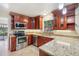 Modern kitchen with granite countertops, stainless steel appliances, and wood cabinets at 105 Oaks Ct, Sanford, FL 32771