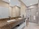 Double vanity bathroom with granite countertop and walk-in shower at 3175 Brasilia Ave, Kissimmee, FL 34747