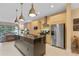 Modern kitchen with island, stainless steel appliances, and pendant lighting at 3175 Brasilia Ave, Kissimmee, FL 34747