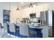 Modern kitchen with stainless steel appliances and blue island at 2709 Scrapbook St, Kissimmee, FL 34746