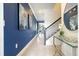 Elegant hallway with dark blue accent wall and staircase at 2709 Scrapbook St, Kissimmee, FL 34746