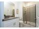 Modern bathroom with gray tile shower and white vanity at 2709 Scrapbook St, Kissimmee, FL 34746