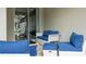 Relaxing patio with comfy wicker furniture and blue cushions at 2709 Scrapbook St, Kissimmee, FL 34746