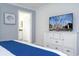 Bedroom with king-size bed and dresser with large TV at 2709 Scrapbook St, Kissimmee, FL 34746