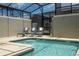 Private screened-in pool and spa with lounge chairs at 2709 Scrapbook St, Kissimmee, FL 34746