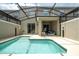 Private screened-in pool and spa with lounge chairs at 2709 Scrapbook St, Kissimmee, FL 34746