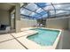 Private screened-in pool and spa with lounge chairs at 2709 Scrapbook St, Kissimmee, FL 34746