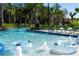 Community pool with a lazy river and plenty of lounge chairs at 2709 Scrapbook St, Kissimmee, FL 34746