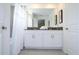 Main bathroom with double vanity, white cabinets, and a shower/tub combo at 2709 Scrapbook St, Kissimmee, FL 34746
