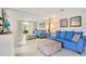 Living room with blue sofa, ottoman, and large flat-screen TV at 899 Jonathan Way # 899, Altamonte Springs, FL 32701