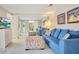Living room with blue sofa, ottoman, and large flat-screen TV at 899 Jonathan Way # 899, Altamonte Springs, FL 32701