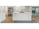 White kitchen island with quartz countertop, perfect for casual dining at 126 Maple Dr, Debary, FL 32713