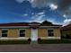 Exterior view of new yellow home with red tile roof at 1646 Cumin Dr, Poinciana, FL 34759
