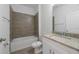 Clean bathroom with a bathtub, toilet and granite countertop at 1646 Cumin Dr, Poinciana, FL 34759