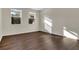 Empty room with dark wood-look floors and abundant natural light at 1102 Welch Hill Cir, Apopka, FL 32712