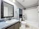 Bathroom boasts a vanity with a framed mirror, a toilet, and a tub at 350 Winter Nellis Cir, Winter Garden, FL 34787