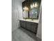 Double vanity bathroom with gray cabinets and gold accents at 625 Disa Dr, Davenport, FL 33837