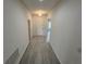 Clean hallway with wood-look floors and access to other rooms at 625 Disa Dr, Davenport, FL 33837