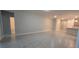 Open living room with gray tile floors and access to bathroom at 1007 Theodore St, Davenport, FL 33837